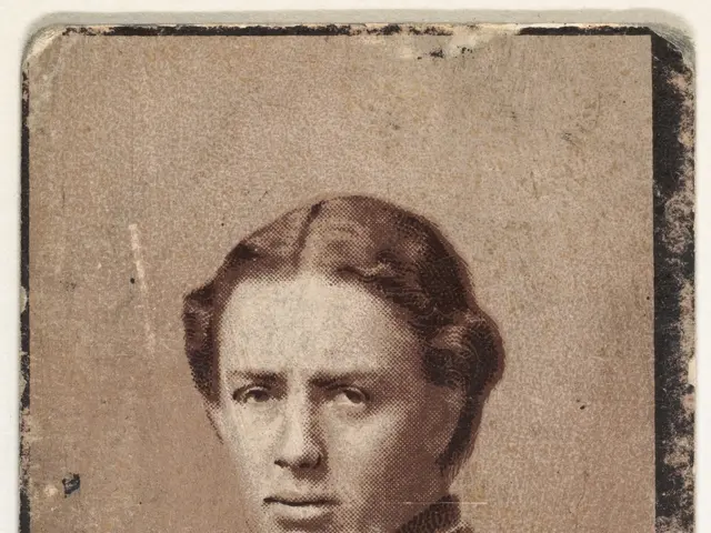 The image shows an old photo of a woman with a serious expression on her face. At the bottom of the...