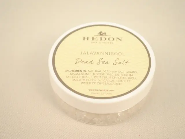 The image shows a white box with a label on it, sitting on a white surface. The label reads...