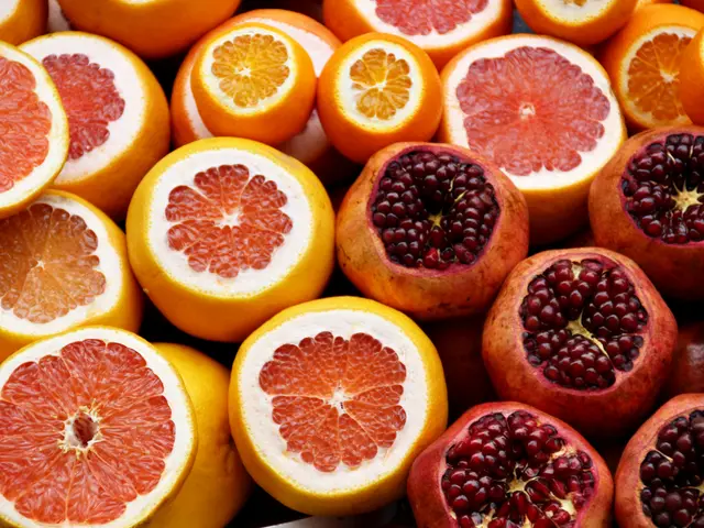 The image shows a box filled with a variety of citrus fruits, including oranges and pomegranates....