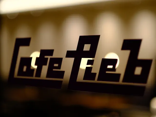 The image shows a coffee shop with a sign that reads "Coffee Lab" on a glass window, illuminated by...