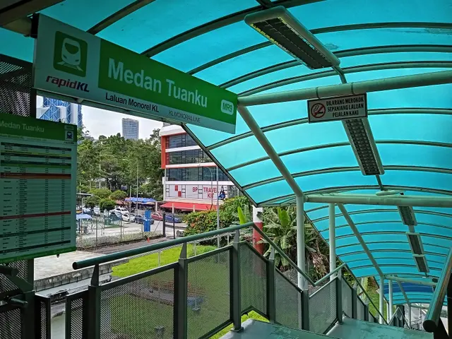 The image shows a train station with a sign that reads "Medan Tuanku" on the left side of the...