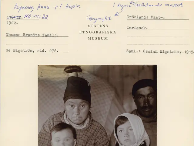 The image shows a black and white photo of a family of three, with the man in the center holding a...