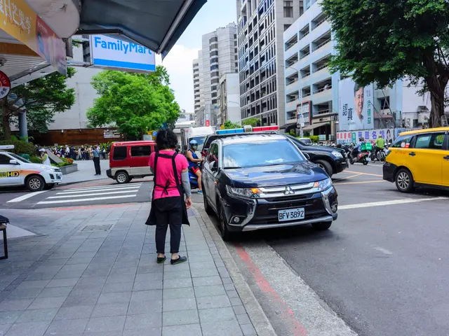 The image shows a woman walking down a sidewalk next to a yellow taxi. There are other vehicles on...