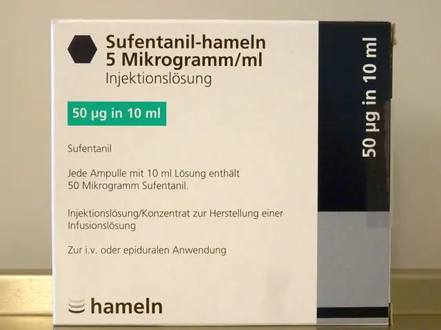 The image shows a white box with text on it sitting on top of a table, with a wall in the...