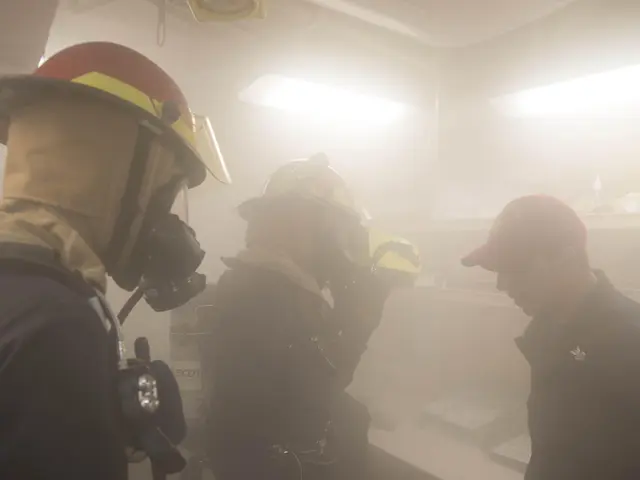 The image shows a group of firefighters in a room with smoke coming out of their mouths. They are...