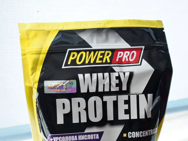 The image shows a packet of Power Pro Whey Protein on a white surface. The packet is a light blue...