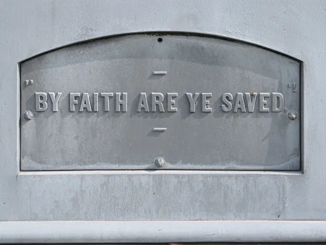 The image shows a plaque on the side of a building that reads "By Faith Are Ye Saved". The plaque...