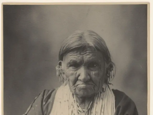 The image shows an old black and white photo of an Indian woman with a human face. She is wearing...