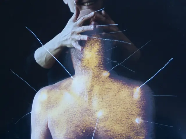 The image shows a man with a smile on his face, receiving acupuncture points on his back against a...