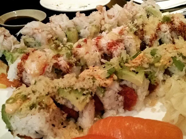 In this image there are some items served on one of the plates, a bowl with sauce.