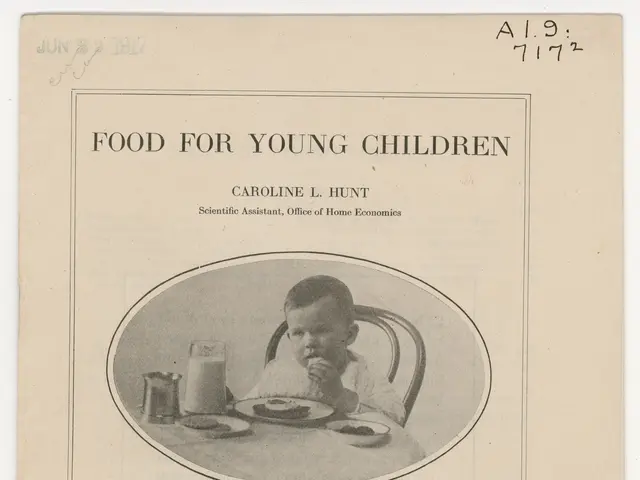 The image shows a young child sitting at a table with a plate of food in front of them. The plate...