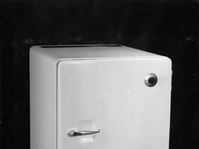 The image shows a black and white photo of a small refrigerator with a door open, revealing a safe...
