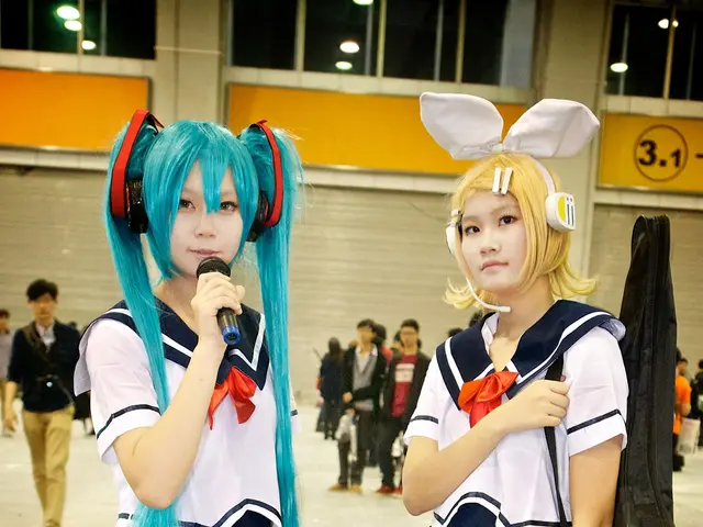 The image shows two girls in school uniforms standing next to each other, one of them holding a...