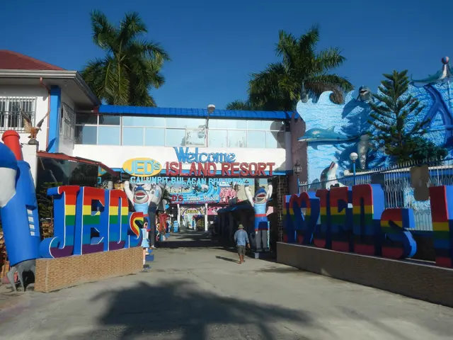 The image shows the entrance to Jed's Island Resort in Cebu City, Philippines. There are people...