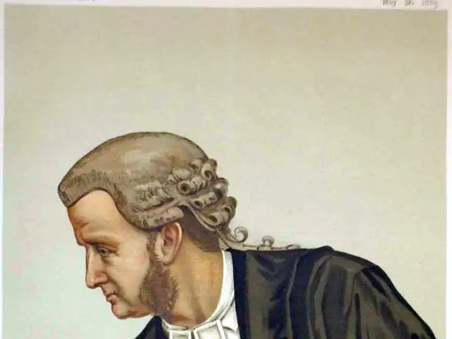 The image shows a man in a black robe sitting at a table with books and a feather quill pen in...